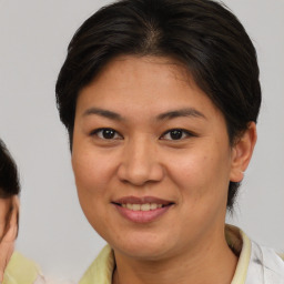 Joyful white young-adult female with medium  brown hair and brown eyes