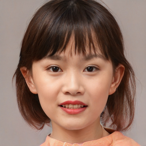 Joyful asian child female with medium  brown hair and brown eyes