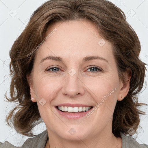 Joyful white adult female with medium  brown hair and green eyes