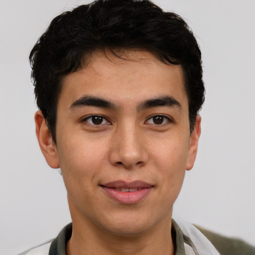 Joyful latino young-adult male with short  brown hair and brown eyes
