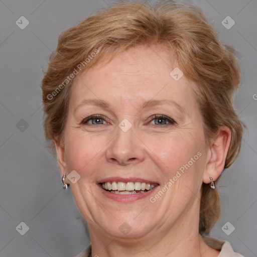 Joyful white adult female with medium  brown hair and blue eyes