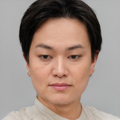 Joyful asian young-adult female with short  brown hair and brown eyes