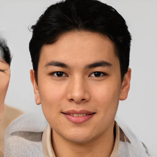 Joyful asian young-adult male with short  brown hair and brown eyes