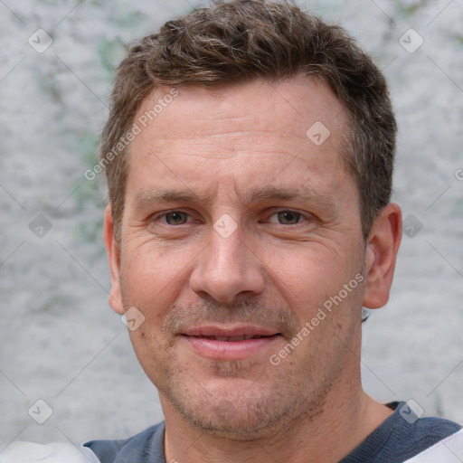 Joyful white adult male with short  brown hair and grey eyes