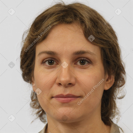 Joyful white adult female with medium  brown hair and green eyes