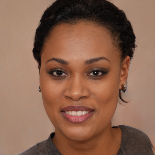 Joyful black young-adult female with short  black hair and brown eyes