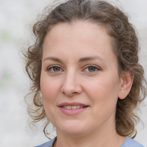 Joyful white young-adult female with medium  brown hair and blue eyes