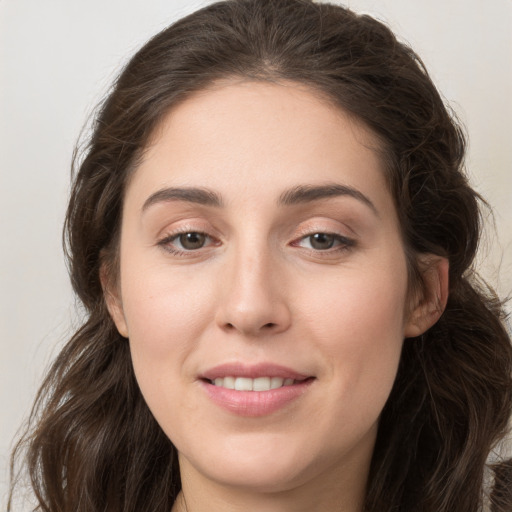 Joyful white young-adult female with long  brown hair and grey eyes