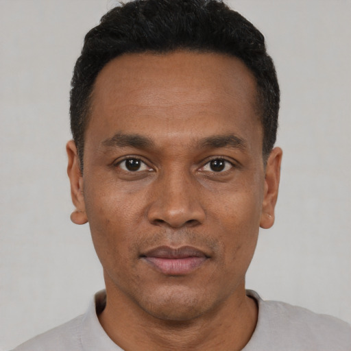 Neutral black young-adult male with short  black hair and brown eyes