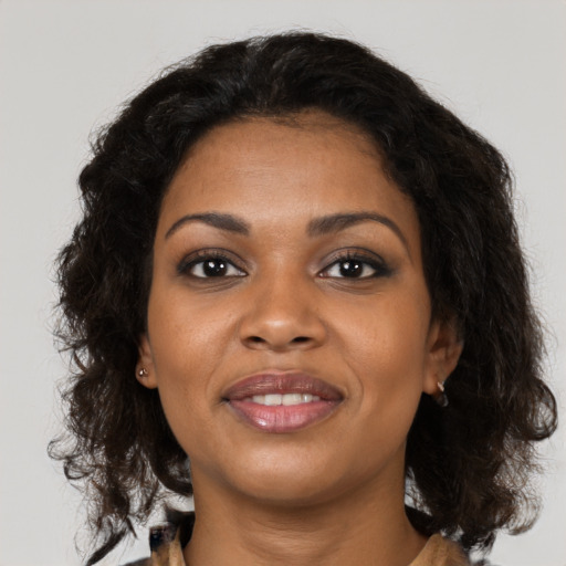 Joyful black young-adult female with medium  brown hair and brown eyes