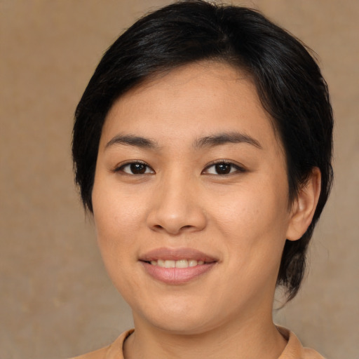Joyful asian young-adult female with medium  brown hair and brown eyes
