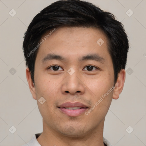 Joyful asian young-adult male with short  black hair and brown eyes