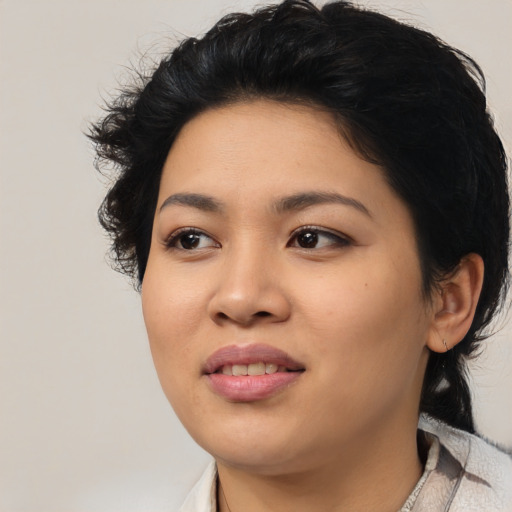 Joyful asian young-adult female with medium  black hair and brown eyes