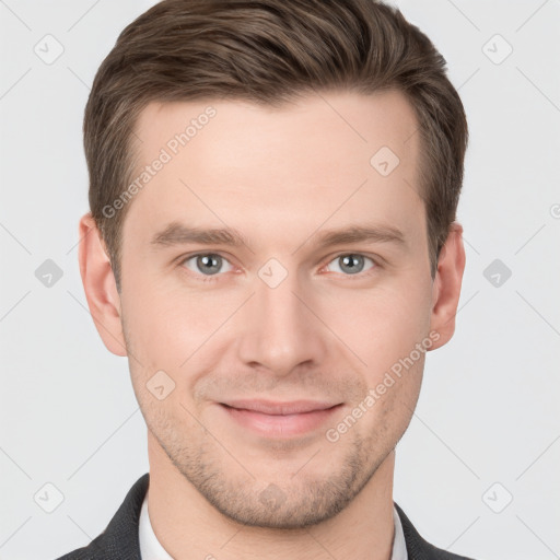 Joyful white young-adult male with short  brown hair and grey eyes