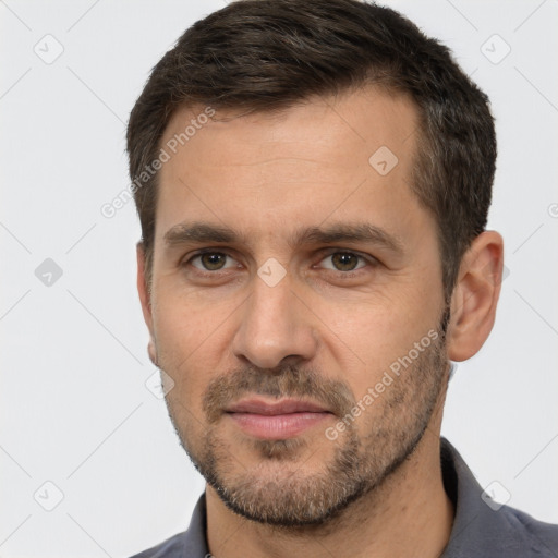 Joyful white adult male with short  brown hair and brown eyes