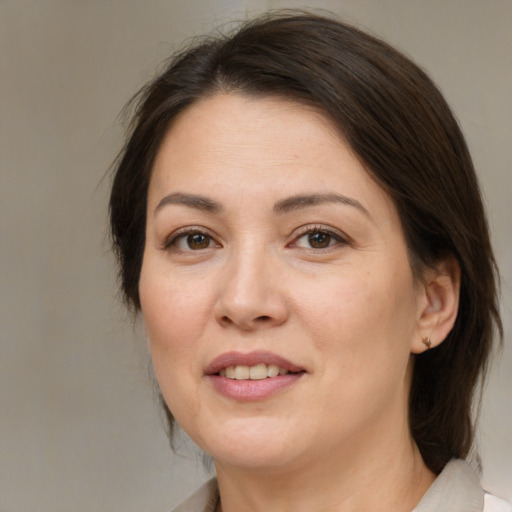Joyful white adult female with medium  brown hair and brown eyes
