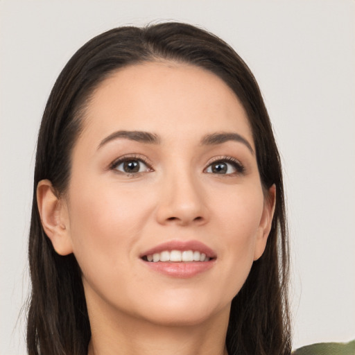 Joyful white young-adult female with long  brown hair and brown eyes