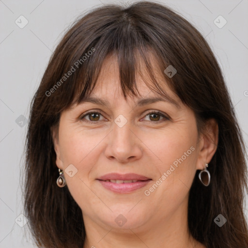 Joyful white adult female with long  brown hair and brown eyes