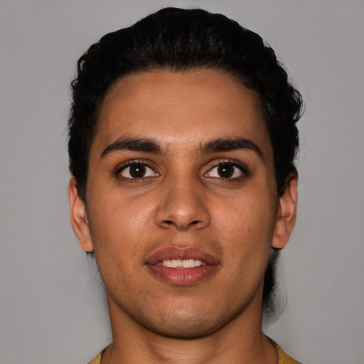 Joyful white young-adult male with short  black hair and brown eyes