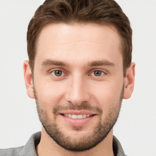 Joyful white young-adult male with short  brown hair and brown eyes