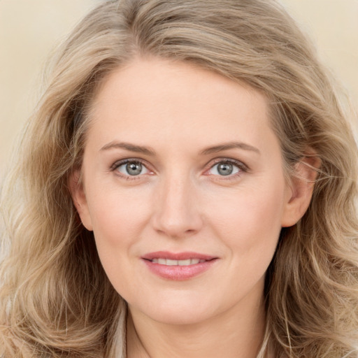 Joyful white young-adult female with long  brown hair and blue eyes