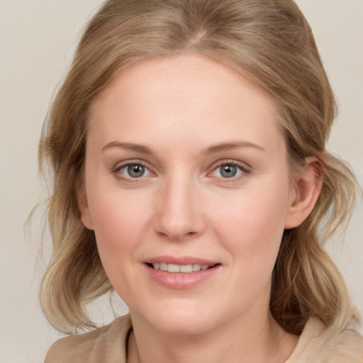 Joyful white young-adult female with medium  brown hair and blue eyes