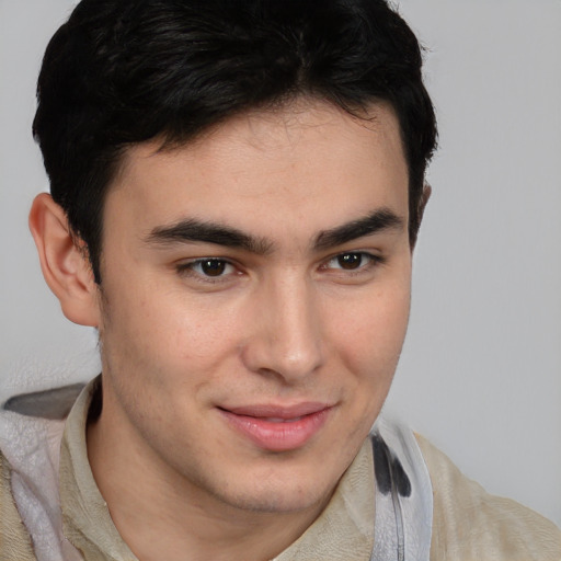 Joyful latino young-adult male with short  brown hair and brown eyes