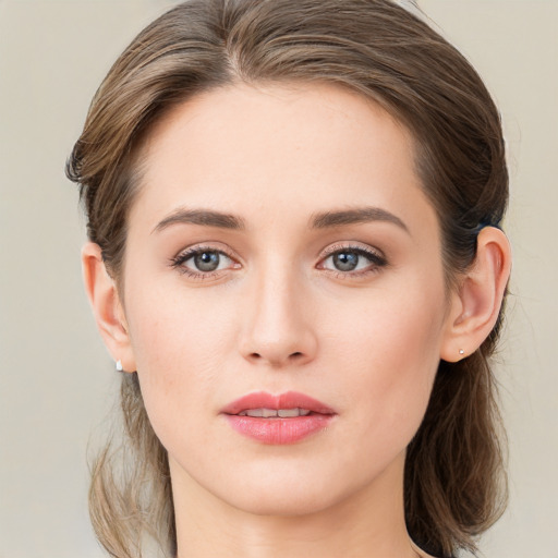 Joyful white young-adult female with medium  brown hair and green eyes