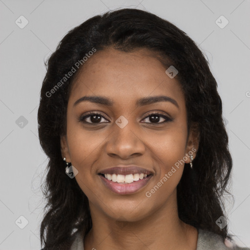 Joyful black young-adult female with long  black hair and brown eyes