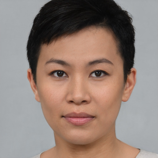 Joyful asian young-adult female with short  black hair and brown eyes