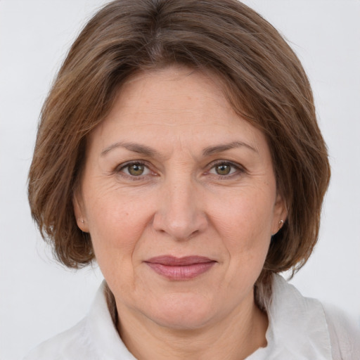 Joyful white adult female with medium  brown hair and brown eyes