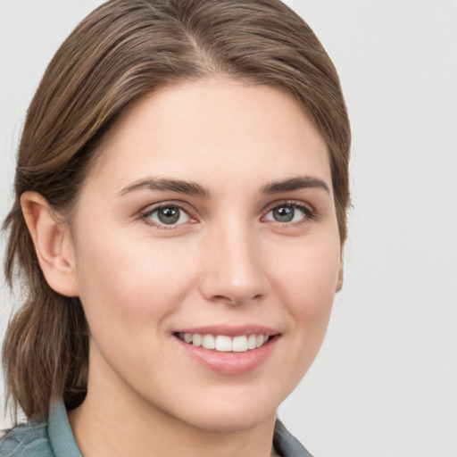 Joyful white young-adult female with medium  brown hair and grey eyes