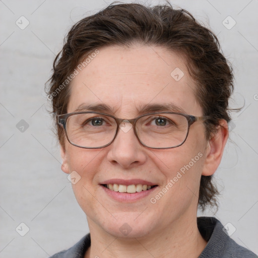 Joyful white adult female with medium  brown hair and blue eyes