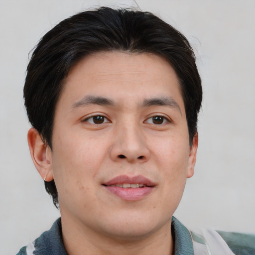 Joyful asian young-adult male with short  brown hair and brown eyes