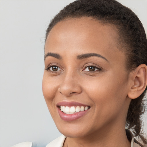 Joyful white young-adult female with long  brown hair and brown eyes