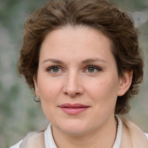 Joyful white young-adult female with medium  brown hair and green eyes