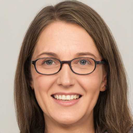 Joyful white adult female with long  brown hair and brown eyes