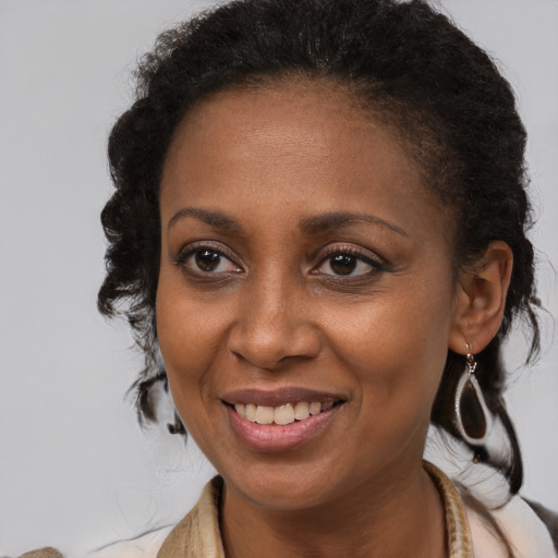 Joyful black young-adult female with medium  brown hair and brown eyes