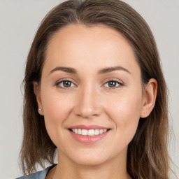 Joyful white young-adult female with long  brown hair and grey eyes