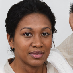 Joyful black adult female with short  brown hair and brown eyes