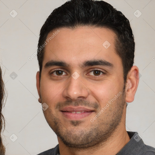 Joyful white young-adult male with short  black hair and brown eyes