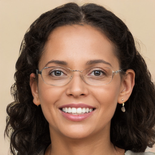 Joyful white adult female with long  brown hair and brown eyes