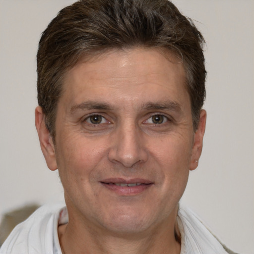 Joyful white adult male with short  brown hair and brown eyes