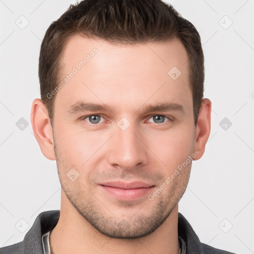 Joyful white young-adult male with short  brown hair and grey eyes