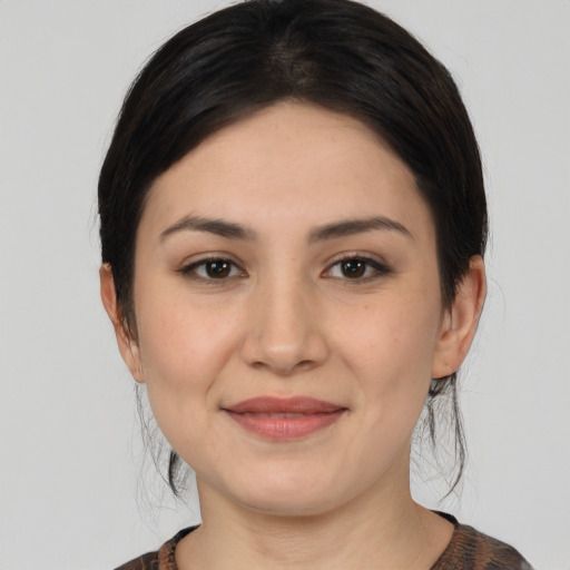 Joyful white young-adult female with medium  black hair and brown eyes