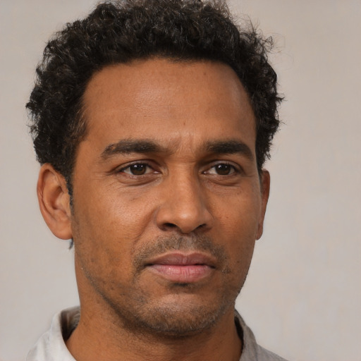 Neutral latino adult male with short  brown hair and brown eyes