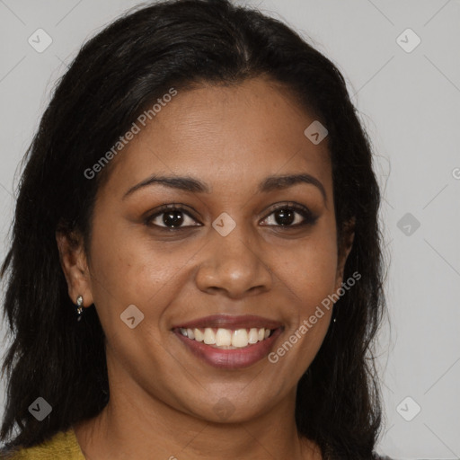 Joyful black young-adult female with long  brown hair and brown eyes