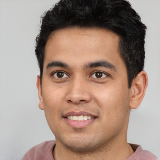 Joyful latino young-adult male with short  black hair and brown eyes