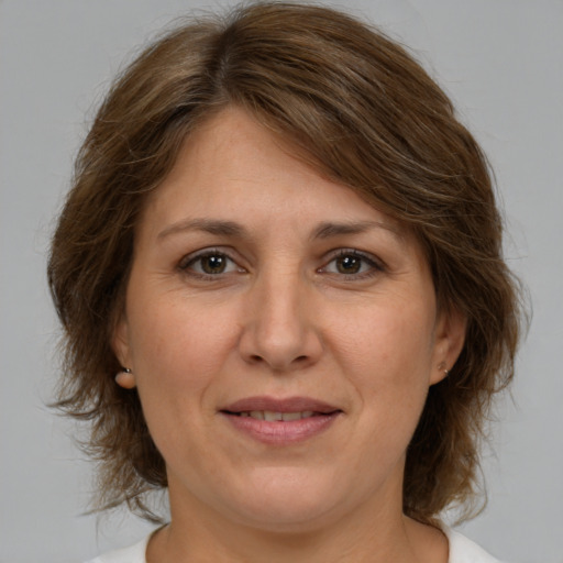 Joyful white adult female with medium  brown hair and brown eyes