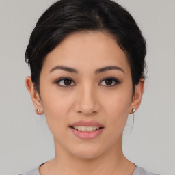 Joyful asian young-adult female with short  brown hair and brown eyes